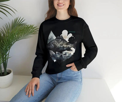 Fishing sweatshirt color black, context woman wearing sweatshirt. Print design on the front side, of a big fish, with reflection and background of misty grey mountains. Brand logo in Plankton Green above the design, on the left side.