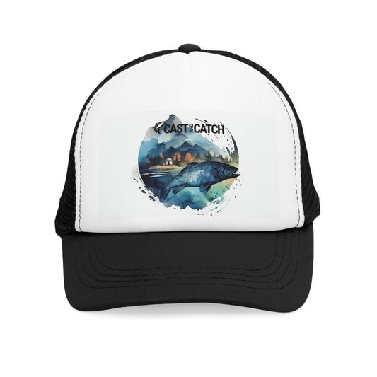 Black mesh fishing hat, front view. Front of the hat is white and has a print design of a blue fish in the background of lake and cabin, vivid colors. Brand logo in black printed above the design.